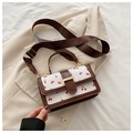 Close-up of white crossbody bag with cherry prints and brown fabric shoulder strap - Brown