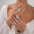 Detailed view of silver alloy ring set with amber and blue acrylic stones on model - Ring Set / Silver (6234)