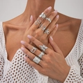 Detail of silver starfish and coral rings worn by model in a boho jewelry set - Light Gold Ocean Nature Theme Style