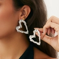 Close-up of silver-tone large heart earrings with textured crinkle surface on model - Heart Wrinkled Style - Silver (3642)