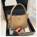 Minimalist khaki litchi grain leather bucket bag with silk scarf and gold hardware - Khaki