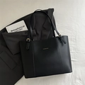 Minimalist black matte leather tote bag with adjustable strap and fashion text - Black