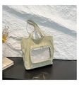 Detail of light green tote bag with pleated nylon texture and transparent mesh pocket - Green