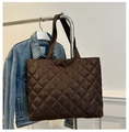 Detail of dark brown quilted tote bag with diamond stitching and wide shoulder strap - Brown
