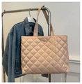 Detail of champagne quilted tote bag with large capacity and soft sheen fabric texture - Khaki