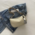 Beige nylon crossbody bag with patterned wide strap and OOTM logo over denim jacket - Green