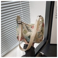 Close-up of floral embroidery on beige canvas bag with adjustable fabric strap - Off White