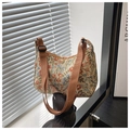 Detail of floral tapestry jacquard fabric with woven floral patterns on a hobo bag - Brown