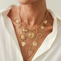 Detail of layered gold necklaces with heart and flower pendants on white shirt - Gold Necklace (7317)