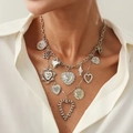 Silver multi-pendant necklace with heart and clover charms worn on a white shirt - Silver Necklace (7317)