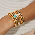 Détail d'un ensemble de bracelets perlés superposés avec perles dorées et breloques de croix - Ensemble 8 Pièces Multicolore (6441)