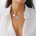 Close-up of a silver heart pendant necklace set with various textures on a model - Multi-Texture Heart Pendant Necklace / Silver (7297)