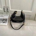 Minimalist black crescent shoulder bag in glossy patent leather with gold hardware - Black