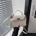 Elegant off-white crossbody bag with gold hardware and classic textured finish - White