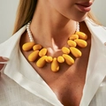 Statement necklace with yellow teardrop acrylic pendants and elegant white faux pearls - Yellow