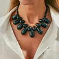 Bohemian black resin teardrop pendant necklace with glossy beads on a white shirt - Black