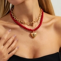Retro red beaded necklace set with golden heart pendant and OT clasp on a model - Red Beads Gold Heart Style (06931)