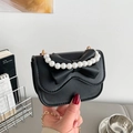 Mini black leather crossbody bag featuring a pearl handle and large bow detail design - Black