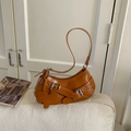 Brown faux leather underarm bag with metal buckles and cute bunny charm on sofa - Caramel Brown - Bunny Charm / Brown