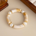 Detailed close-up of marble-patterned resin beads and white pearls on an elegant bracelet - Pearl Spacer Style (3006) / Off White