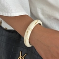 Breiter cremeweißer Harzarmreif mit brauner Marmortextur am weiblichen Handgelenk - Beige-02929
