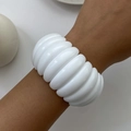 Detail shot of chunky cream white acrylic modular bracelet worn on wrist against white - White