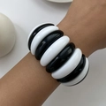 Detail of wide chunky black and white resin bangle bracelet with a smooth glossy finish - Black and White Mixed
