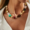 Close-up of bohemian resin beads and metallic accents on a model wearing a linen shirt - Gold (07412)