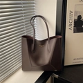 Dark brown large capacity tote bag with gold lettering shown in a modern interior setting - Brown