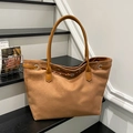 Retro brown suede tote bag with leather straps on a black wooden step display - Brown