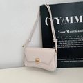 Elegant beige baguette shoulder bag with gold clasp and unique curved bottom design - White