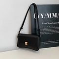 Minimalist black baguette shoulder bag with golden buckle and curved bottom design - Black