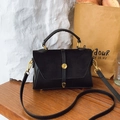 Retro black matte crossbody bag with gold buckle on a stylish textured background - Black
