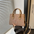 Beige mini tote bag with red cherry prints featuring top handles and a thin crossbody strap - Khaki