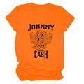 Close-up of Johnny Cash graphic with cowboy boots and flowers on orange cotton T-shirt - S / Orange (Black Text)
