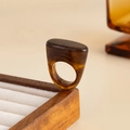 Detailed view of thick resin ring with amber marble texture on wooden display stand - Deep Coffee-00943