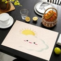 Mexican style linen placemat with sun and cloud pattern on dark wood dining table - Sun and Cloud Duo