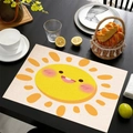 Linen placemat with cartoon sun pattern on a black wooden dining table with tableware - Light Woven Sun
