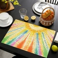 Linen placemat with vibrant watercolor sunburst pattern on a black wooden dining table - Watercolor Dot Sun