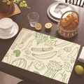 Linen placemat with green vegetable line art patterns on a rustic wooden dining table - 30cm x 45cm