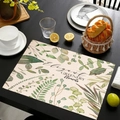 Detail of linen placemat featuring green plant prints and Elegant Greenery text on a table - Elegant Greenery Style (cd-1-5) / 45cmx30cm