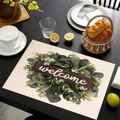 Rectangular linen placemat featuring green leaves and welcome text on a dark table - Welcome Wood Grain Style (cd-1-2) / 45cmx30cm