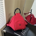 Red triangular nylon backpack and crossbody bag with braided rope handle and metal logo - Red