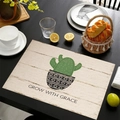 Detailed fabric texture of linen placemat featuring green cactus print and graceful text - Grow With Grace Cactus