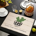 Linen placemat with cactus print and Plant Your Own Happiness text on black table - Plant Your Own Happiness