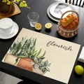 Linen placemat with green succulent print and flourish text on black table - Flourish Snake Plant