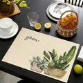 Linen placemat with green potted plant print and grow text on a dark wooden table - Grow Potted Plants