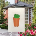 Linen garden flag with cactus pattern displayed on a metal stand in a backyard setting - Cartoon Potted Cactus Style