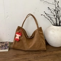 Retro brown faux leather tote bag with red apple charm in minimalist home setting - With Pendant / Brown