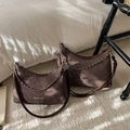 Borsa a mezzaluna in camoscio marrone scuro con catena in metallo e tracolla su letto - Grande / Marrone